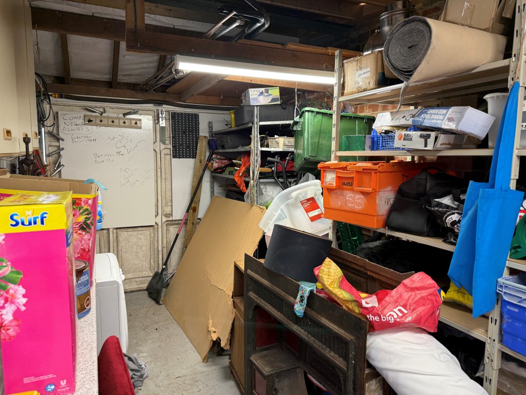 Lot: 137 - BUNGALOW WITH POTENTIAL IN FAVOURED LOCATION - Front garage with shelving